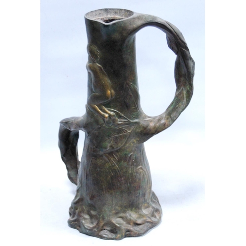 165 - Art Nouveau twin-handled pewter jug decorated with nude figures amongst the reeds, 32cm high.