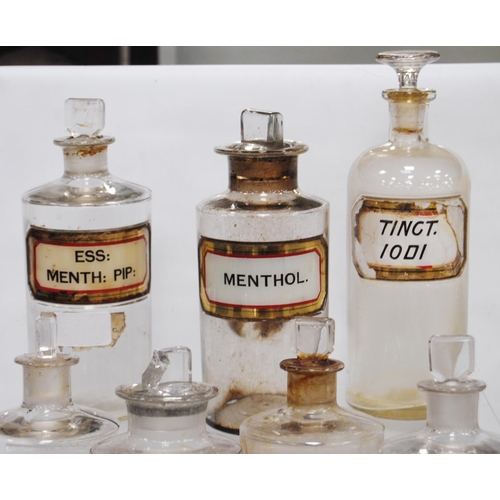 208 - Collection of ten antique glass chemist's jars of medium size, named in black lettering on red, whit... 