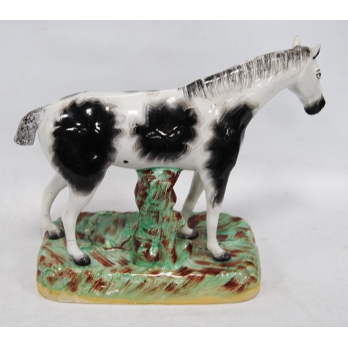 222 - Late 19th century Staffordshire figure of a black and white horse, fixed to a painted base, 24cm hig... 