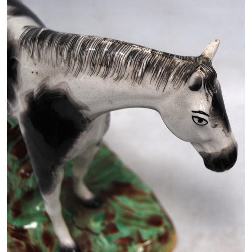 222 - Late 19th century Staffordshire figure of a black and white horse, fixed to a painted base, 24cm hig... 