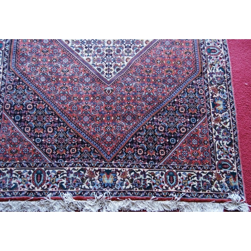 304 - Bidjar rug decorated with graduated geometric centre on a cream and red ground, 178cm x 113cm.