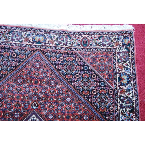 304 - Bidjar rug decorated with graduated geometric centre on a cream and red ground, 178cm x 113cm.