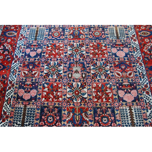 305 - Bakhtiari hand-knotted rug decorated with nine rows of five geometric and floral squares, with a flo... 