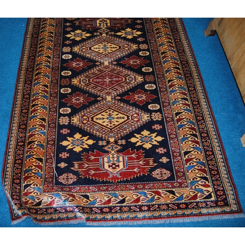 310 - Qashqai rug decorated with five geometric medallions on a blue ground with a red and cream border, 1... 