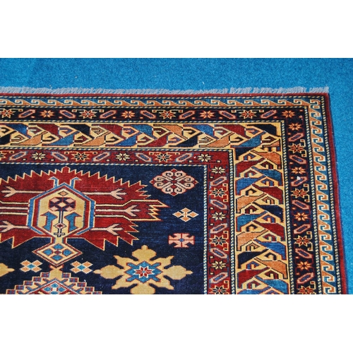 310 - Qashqai rug decorated with five geometric medallions on a blue ground with a red and cream border, 1... 