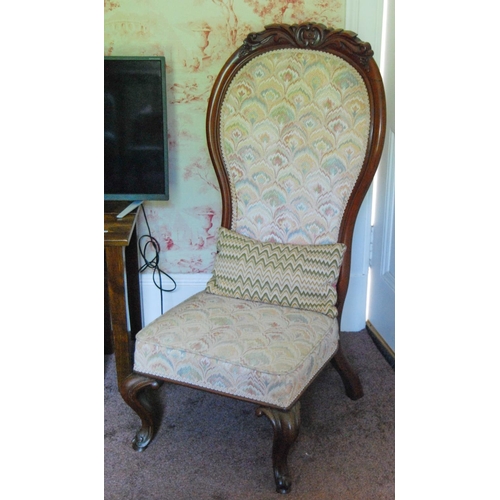 335 - Victorian mahogany spoon-back nursing chair upholstered in later floral fabric, on scroll supports, ... 