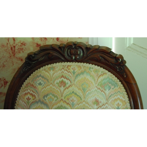 335 - Victorian mahogany spoon-back nursing chair upholstered in later floral fabric, on scroll supports, ... 