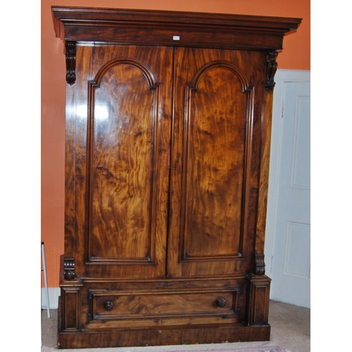 343 - Victorian mahogany wardrobe enclosed by a pair of panel doors over a single drawer, flanked by carve... 