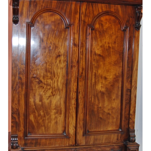 343 - Victorian mahogany wardrobe enclosed by a pair of panel doors over a single drawer, flanked by carve... 