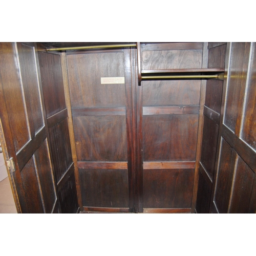 344 - Jacobean revival oak carved two-door wardrobe, 183cm high, 124cm wide and 56cm deep.