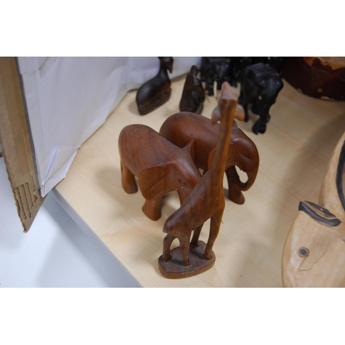 105 - Collection of wooden ornaments to include a burr wood bowl modelled as a fish, figures of deer and a... 