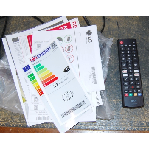 116 - LG television with remote control and instruction booklet.