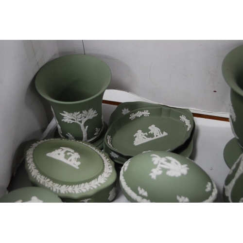 141 - Group of green Wedgwood Jasper ware to include boxes and covers, spill vases, cup, pin dishes etc.  ... 