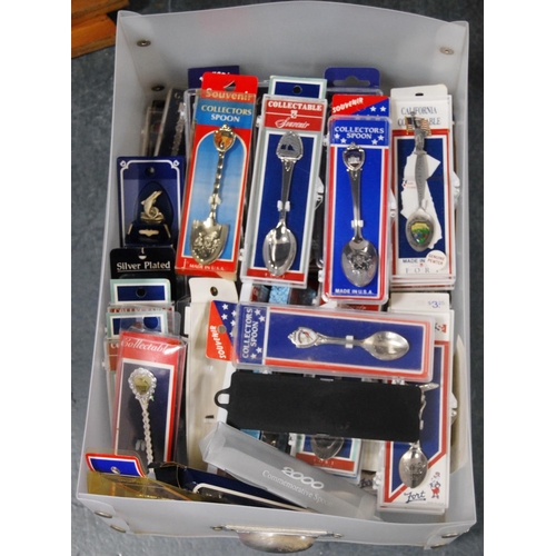 143 - Two cartons containing a large quantity of world souvenir spoons, all boxed.