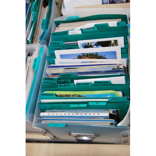 145 - Five boxes containing a large quantity of world postcards, sorted into countries.