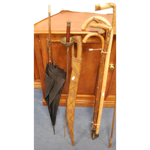 17 - Group of assorted walking sticks, fencing foil, parasol, gun cleaning rod etc.