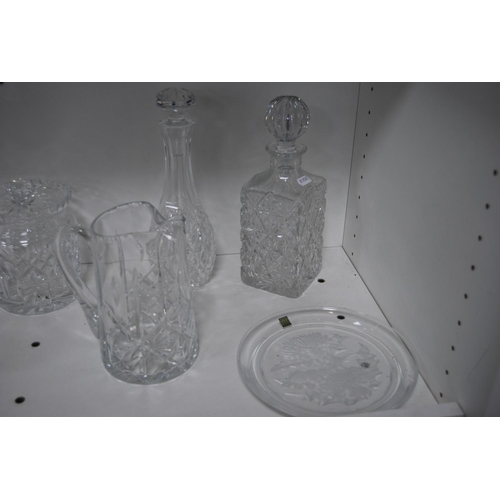 182 - Crystal and cut glass to include a Hoya thistle-decorated plate, two decanters, water jug, biscuit b... 