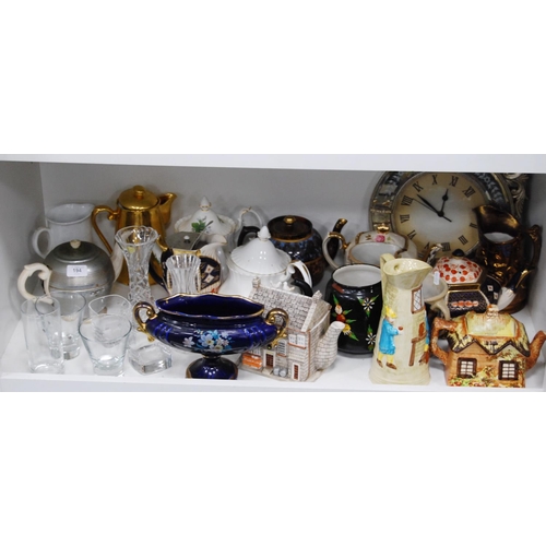 194 - Ceramic and pottery teapots, water pots, lustre jug, modern wall clock, glassware etc (one shelf).