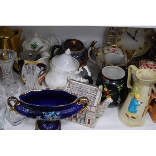 194 - Ceramic and pottery teapots, water pots, lustre jug, modern wall clock, glassware etc (one shelf).