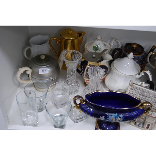 194 - Ceramic and pottery teapots, water pots, lustre jug, modern wall clock, glassware etc (one shelf).