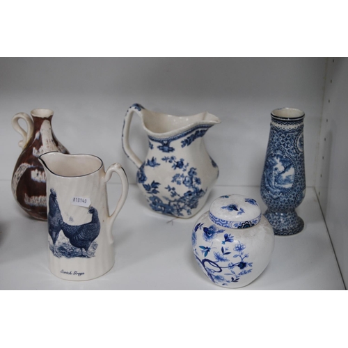 202 - Pottery and ceramic jugs, teapots, tankard etc (two shelves).