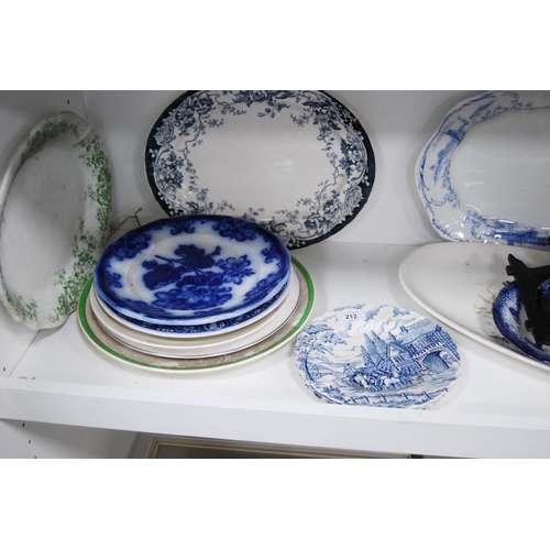 212 - Blue and white pottery ashets, plates, plate stands etc (one shelf).