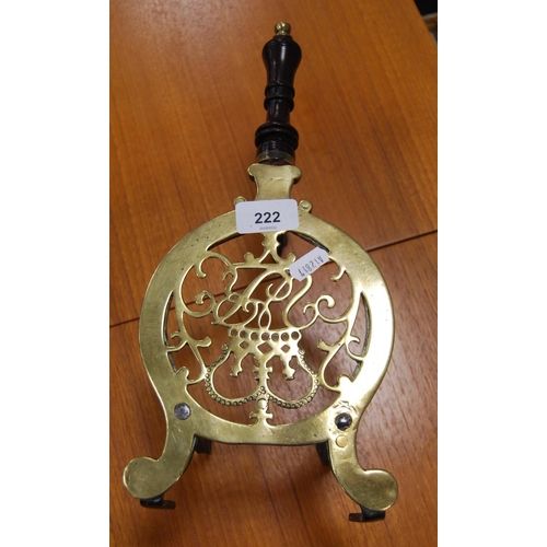 222 - Late Victorian brass trivet with turned wood handle on stylised tripod feet.