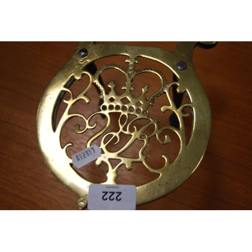 222 - Late Victorian brass trivet with turned wood handle on stylised tripod feet.