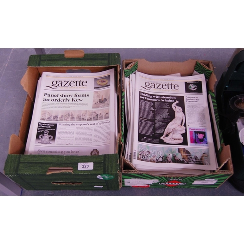 223 - Two cartons containing a quantity of Antiques Trade Gazette magazines.