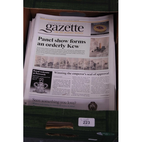 223 - Two cartons containing a quantity of Antiques Trade Gazette magazines.