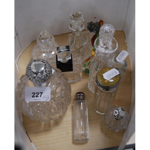 227 - Group of glass toilet and perfume bottles to include one with a silver collar and lid, Murano-style ... 