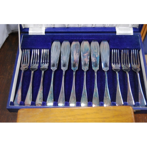 24 - Two sets of six EP fish knives and forks, cased, modern barometer and a modern figure of a golfer.