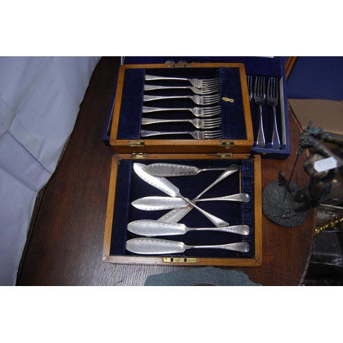 24 - Two sets of six EP fish knives and forks, cased, modern barometer and a modern figure of a golfer.