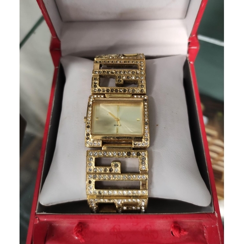 271 - Guess lady's wristwatch and a Limit costume bangle, both boxed.  (2)