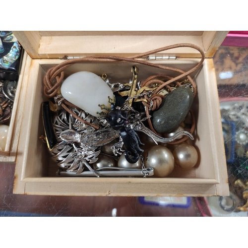 304 - Box of costume jewellery to include a crucifix, beads, fashion watches etc.