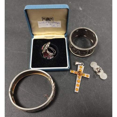 320 - Jewellery to include a silver cross pendant with amber-style stones, WRVS badges, metal bangle, napk... 