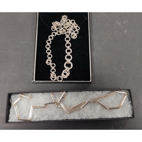 323 - Silver neck chain and a 925 silver neck chain, both boxed, 92.6g gross.