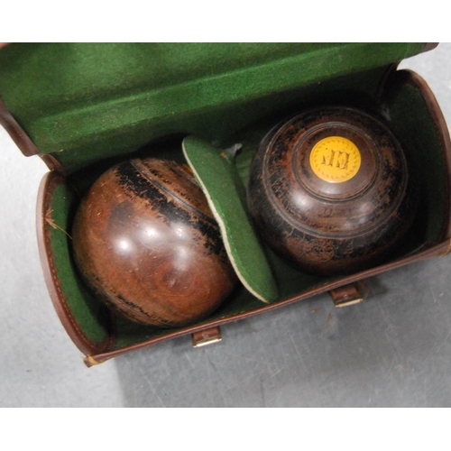 45 - Pair of lawn bowling bowls, monogrammed, cased.