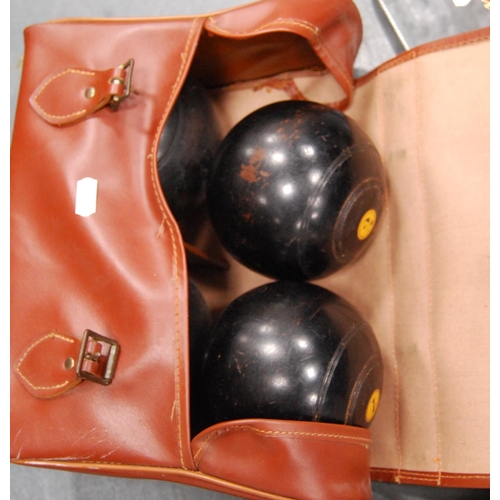 46 - Bag containing a set of four lawn bowling balls, pair of boxed gent's shoes, backpack and a wicker c... 