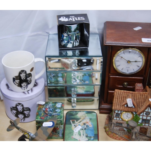 49 - Glass toilet bottle, mantel clock, tins, Beatles Abbey Road mug, another Beatles mug in a tin, orien... 