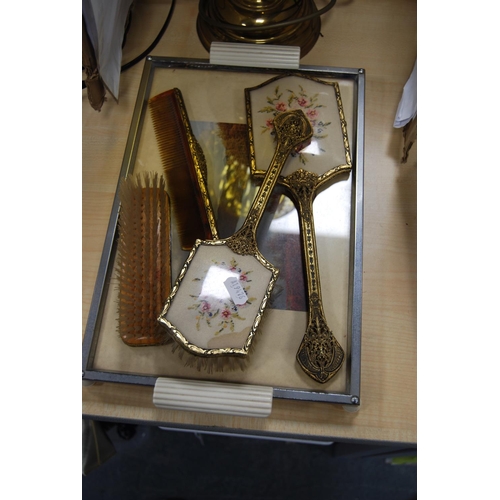 60 - Oil lamp with amber-coloured glass shade and funnel, and a part dressing table brush set and tray.