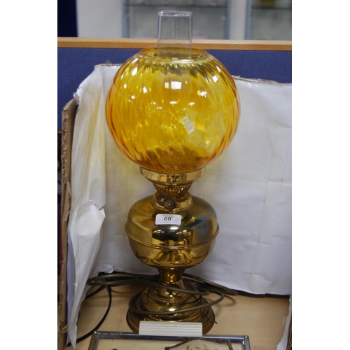 60 - Oil lamp with amber-coloured glass shade and funnel, and a part dressing table brush set and tray.