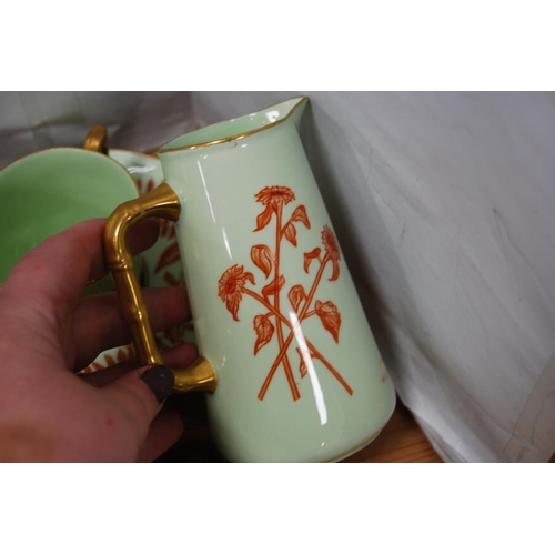 84 - Green and gilt glazed part tea/coffee set, signed 'MAP' to the underside to include teapot (15) and ... 