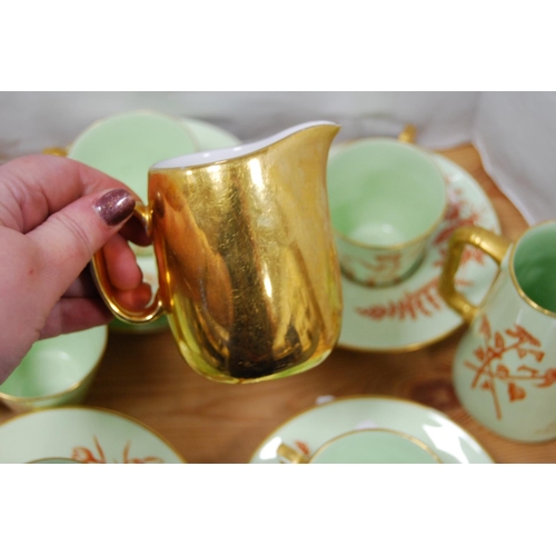 84 - Green and gilt glazed part tea/coffee set, signed 'MAP' to the underside to include teapot (15) and ... 