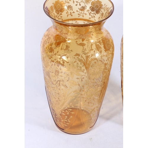 166 - Pair of amber coloured moulded glass baluster vases with applied gilded floral decoration in the man... 