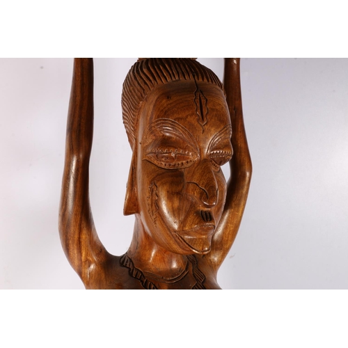 174 - Large African figure of a female carrying water, 90cm tall.