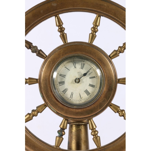 183 - Brass ships wheel table clock, the movement by Ansonia Clock Co, 32cm tall.