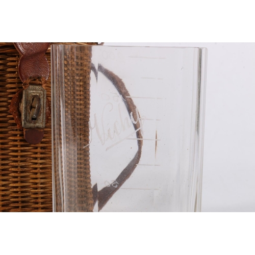 200 - Glass measure in wicker basket carrying case, 12.5cm tall.