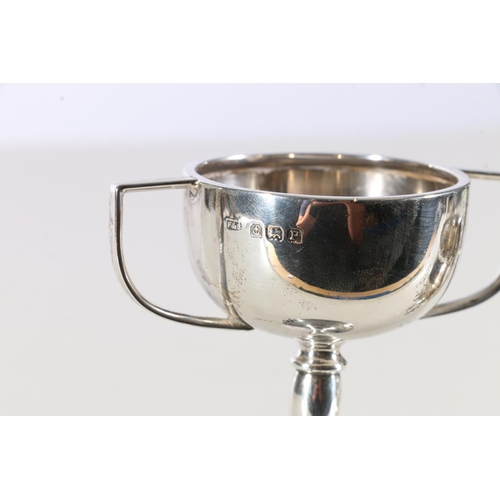 90 - Sterling silver twin handled trophy, Birmingham, 1939, 47 grams and a sterling silver jug, William H... 