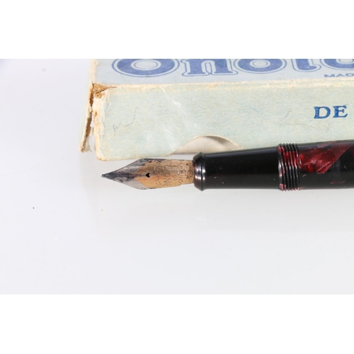 99 - De La Rue Onoto the Pen, plunger filling fountain pen with 14ct gold nib in red marble effect case, ... 